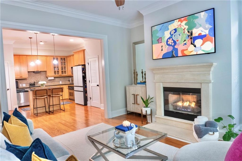 Living room with light wood-style floors, crown mo