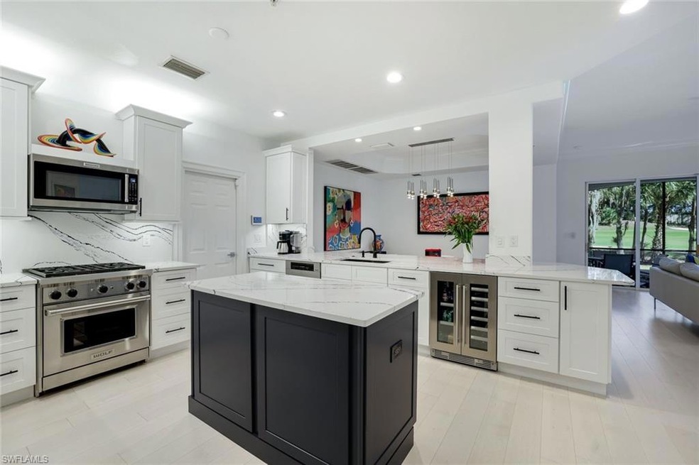 Kitchen with white cabinets, decorative light fixt