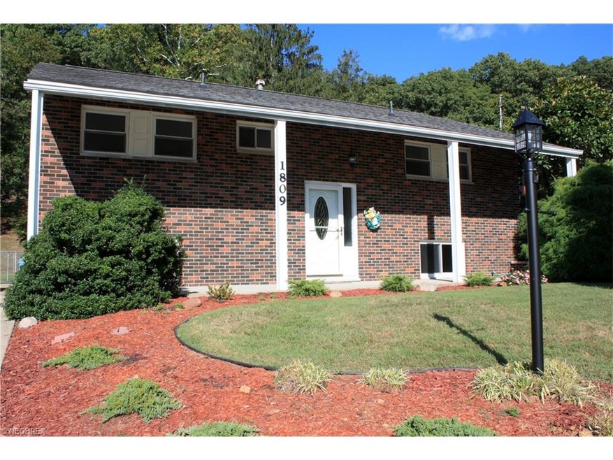 Brick Bi-Level on well landscaped lot with wooded 