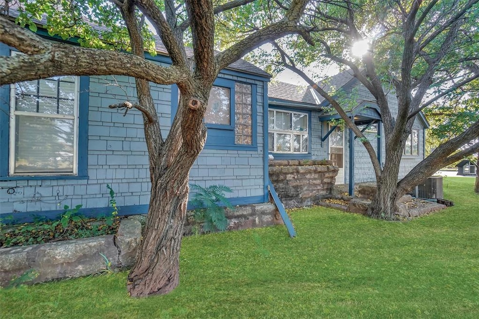 View of front of home featuring a lawn and roof with shingles