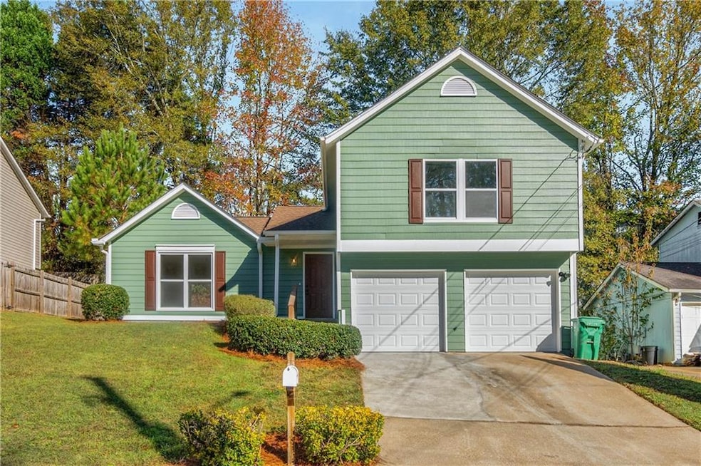 View of front of home with driveway, an attached g