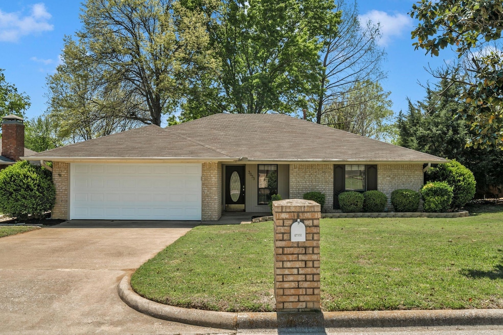 Ranch-style house with a garage, brick siding, a f