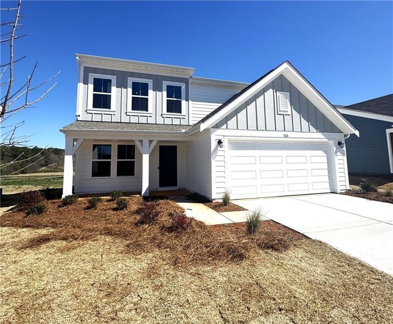 Modern farmhouse featuring driveway, a garage, and board and batten siding