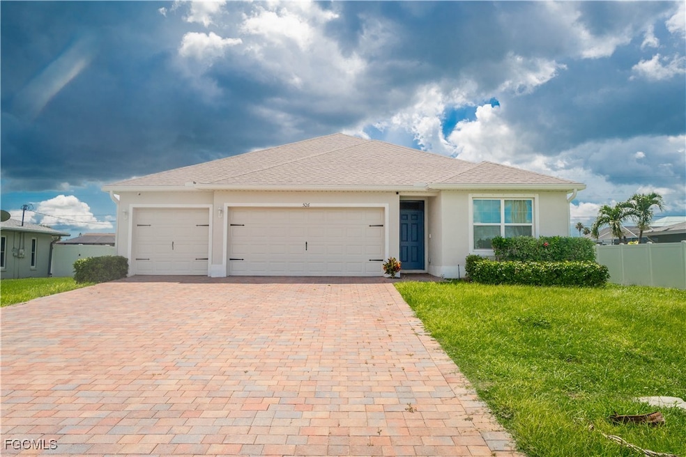 Single story home with decorative driveway, an att