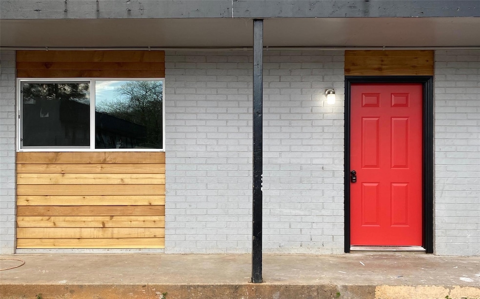 Entrance to property featuring brick siding