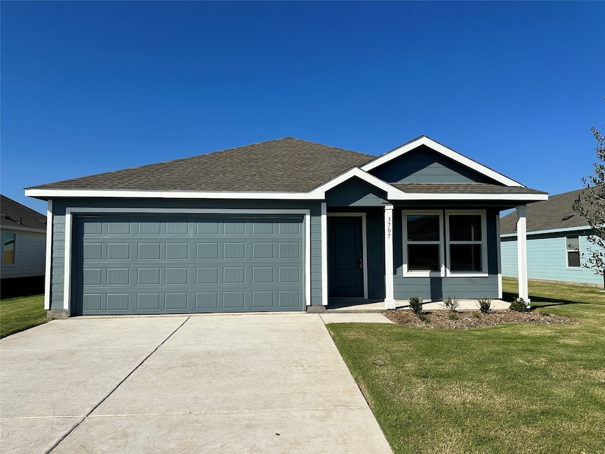 Single story home with a front lawn, driveway, a garage, and a shingled roof