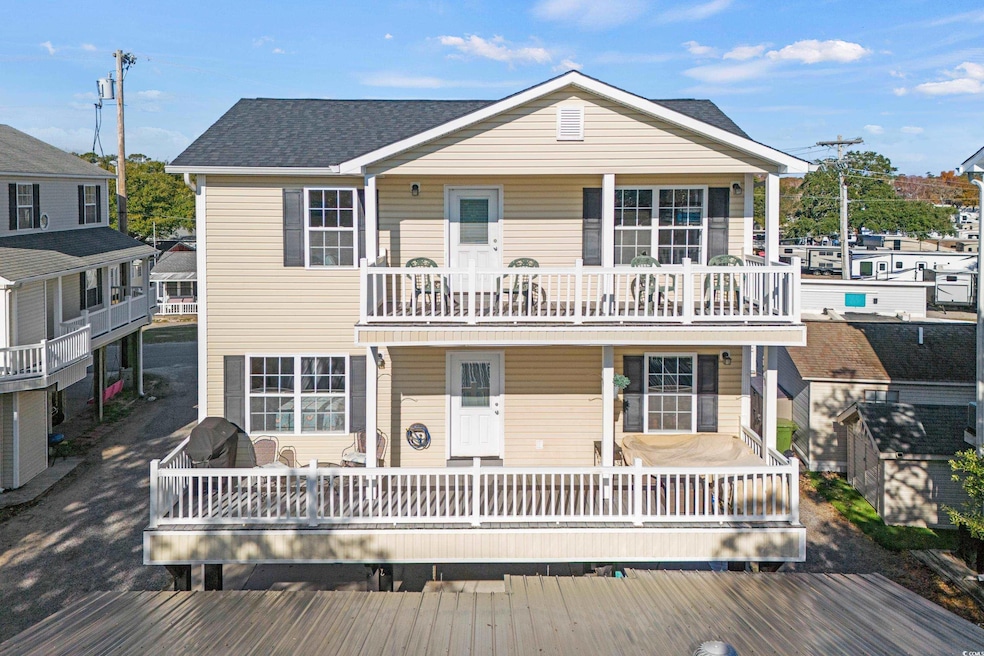 View of front facade with a balcony and roof with 