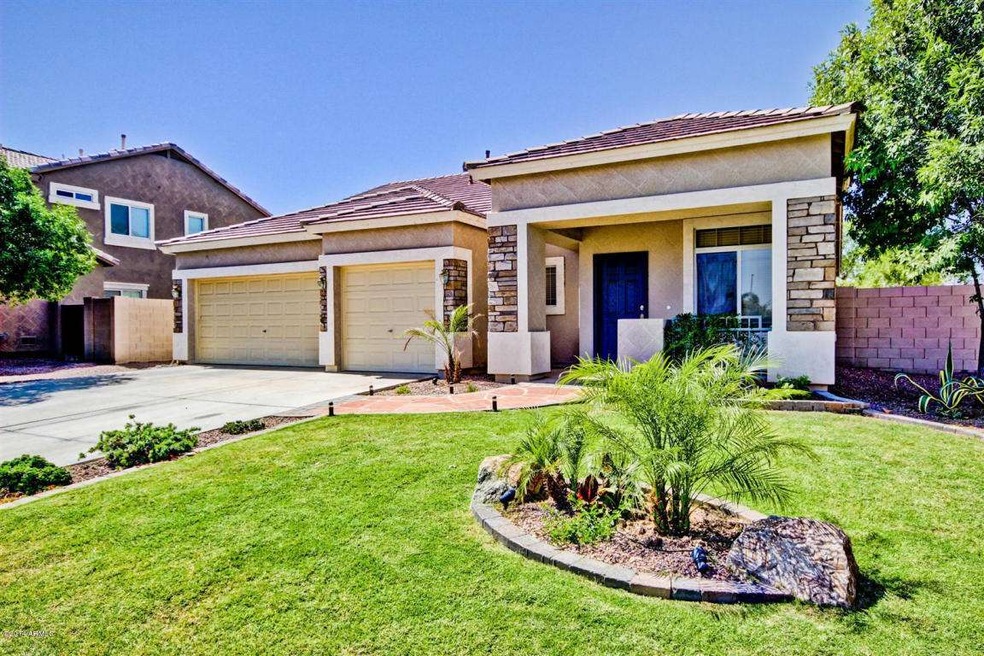 Grassy front yard with covered patio