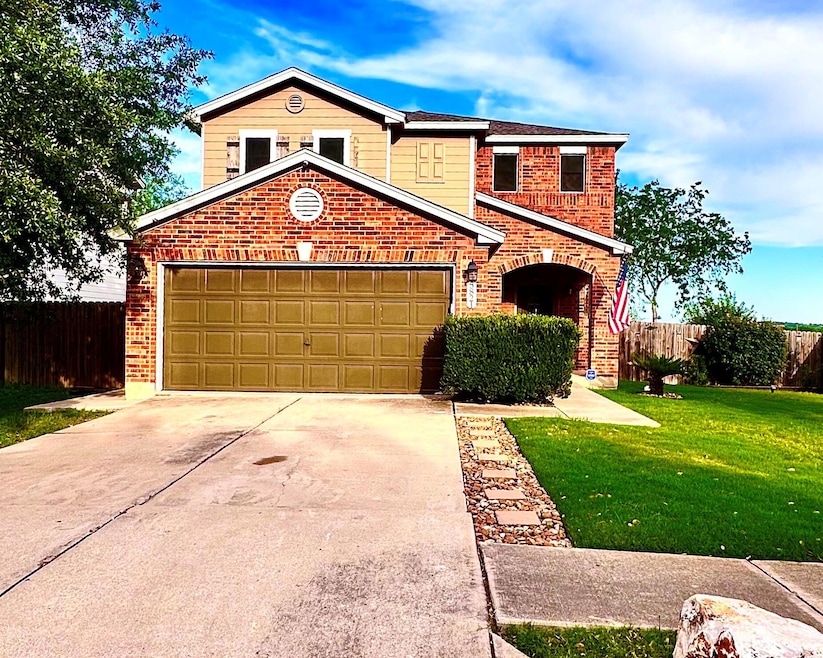 Traditional-style house with brick siding, concre