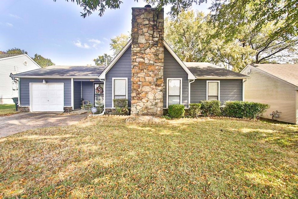 Ranch-style home featuring a garage and a front la