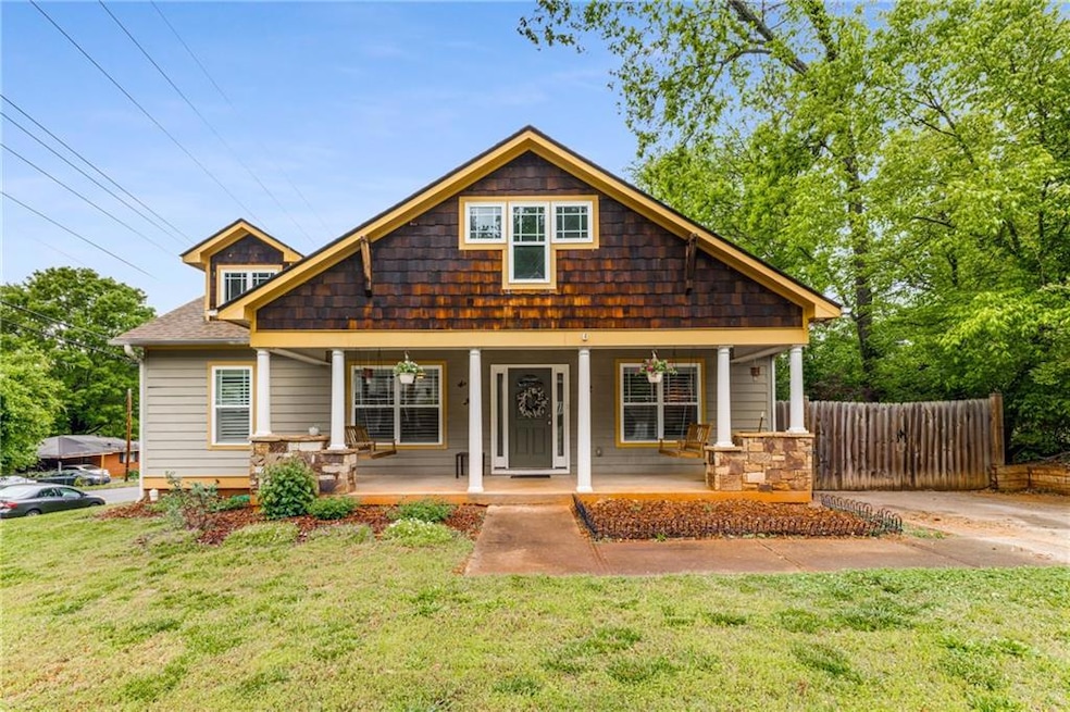 Bungalow-style home featuring a front yard, covere