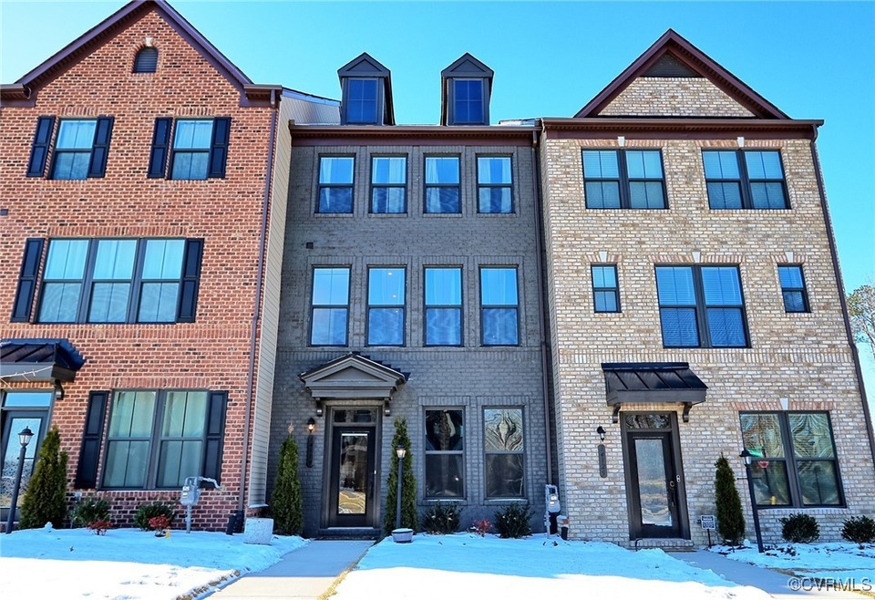 View of property featuring brick siding