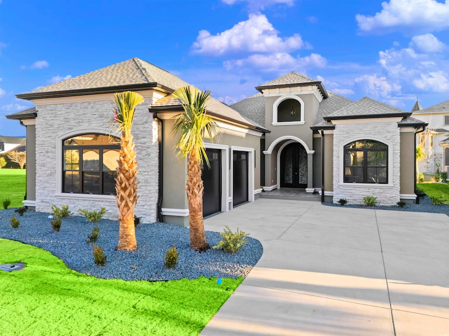 View of front of house with french doors and a gar