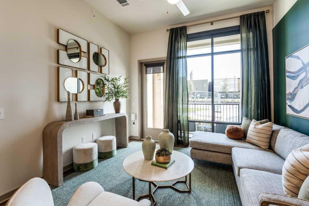Carpeted living room with ceiling fan