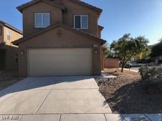 View of front facade with an attached garage, conc