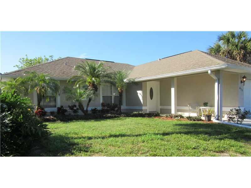 Exterior Front. concrete block home on corner lot