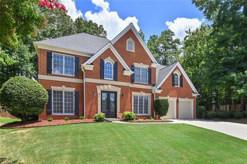 Welcome home!  Leaded glass double front doors add