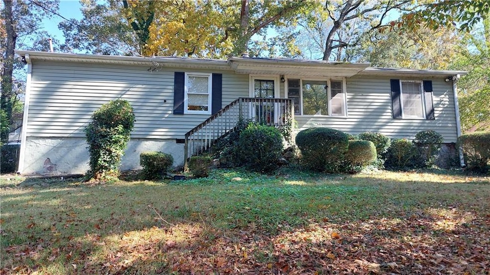 Single story home featuring a front lawn