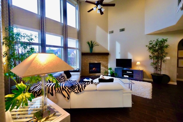 Soaring two-story windows in the principal living area look out to lush, professionally designed landscape. Unique privacy is afforded by the corner site and the fact that there is no residence directly to the rear of the property. neighboring residences are to the left.