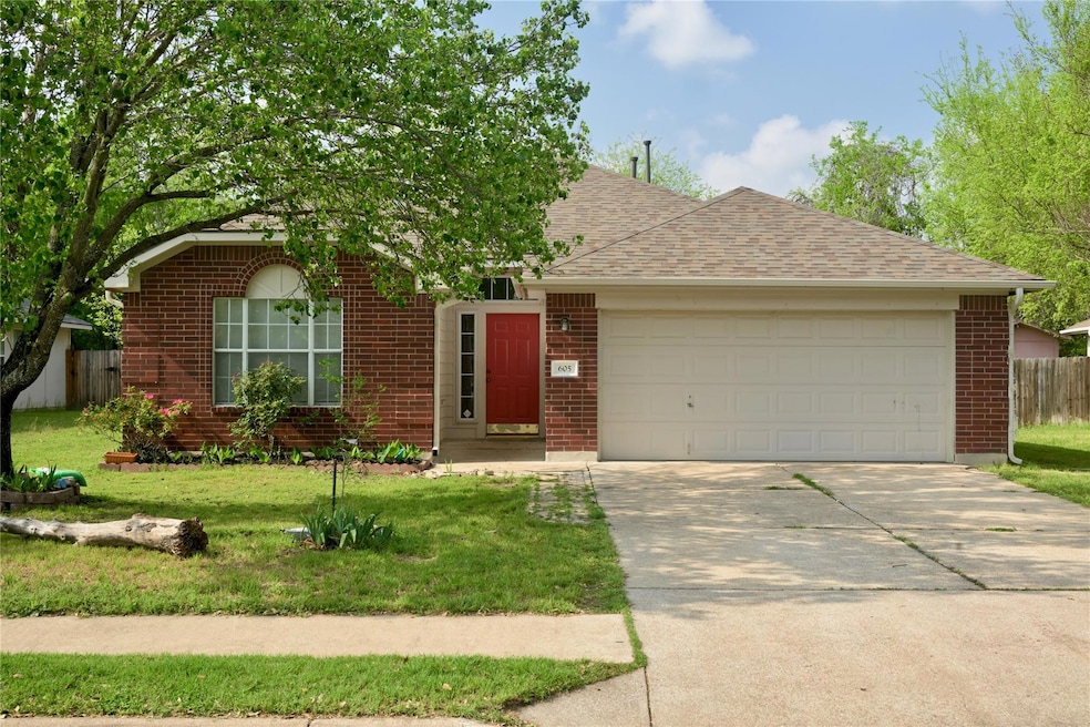 Ranch-style house with concrete driveway, fence, 