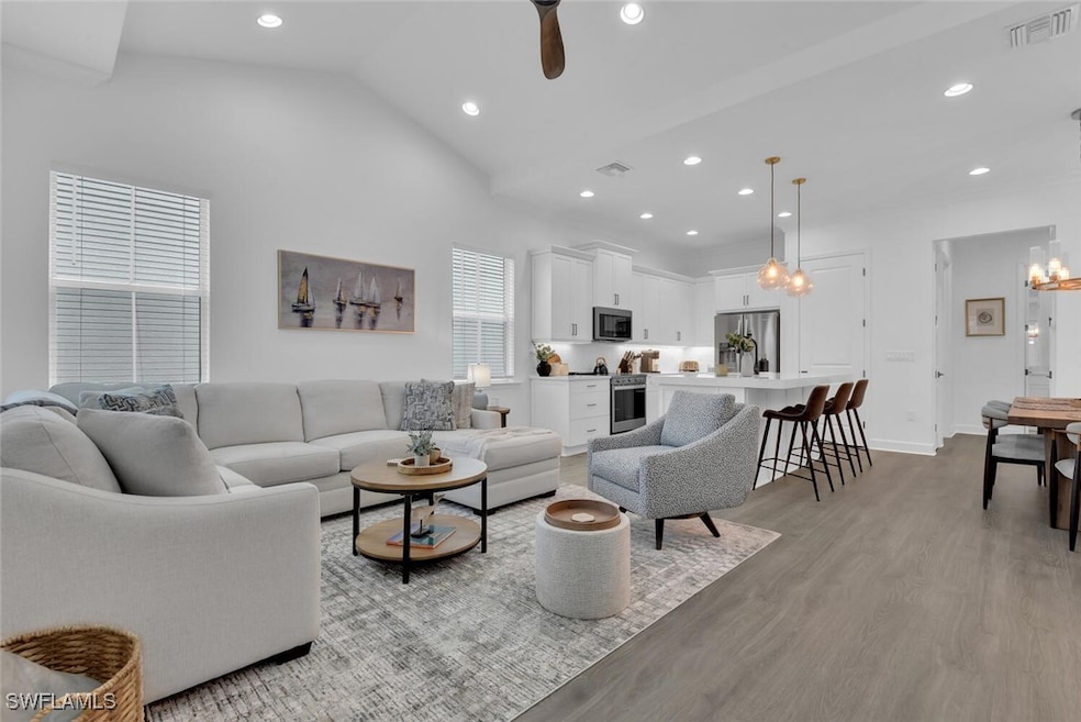 Living area featuring visible vents, baseboards, r