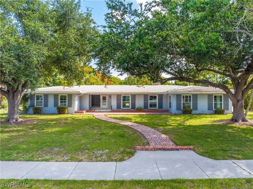Ranch-style house featuring a front lawn