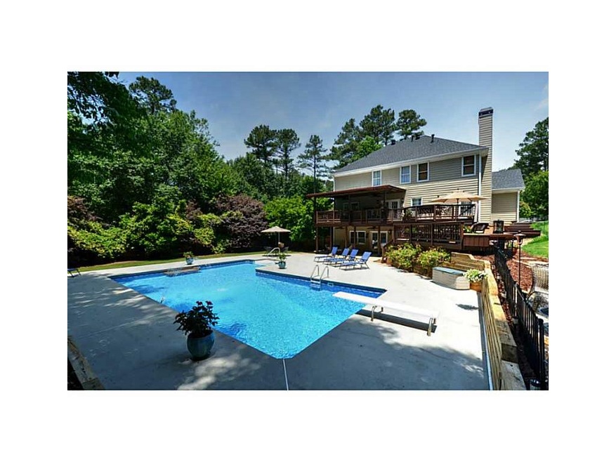 Exterior Back. Multiple covered and uncovered deck