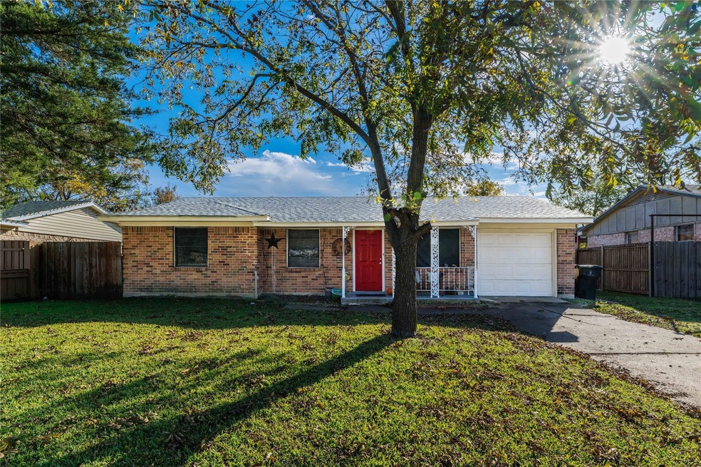 Single story home with a front lawn and a garage