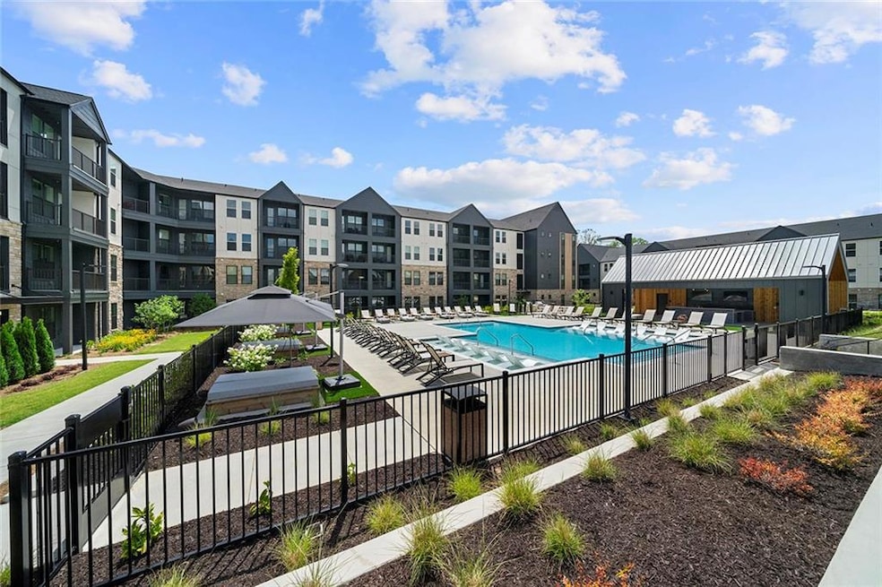 Community pool with a gazebo, fence, and a patio