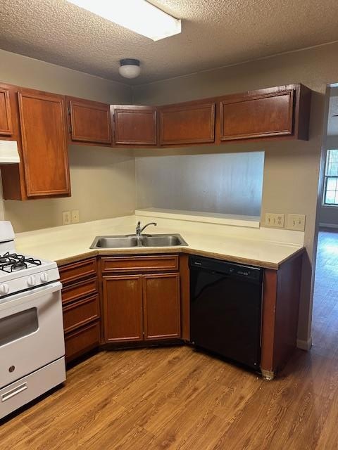 Kitchen featuring dishwasher, stove, a sink, extr