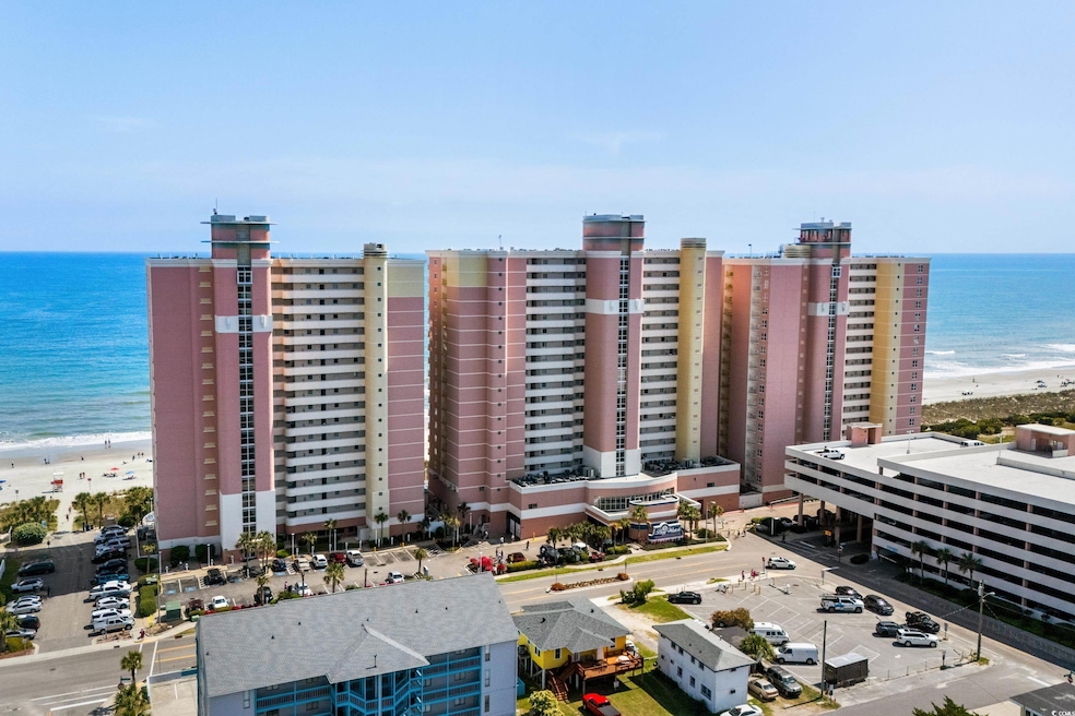 Aerial view featuring a water view and a beach vie