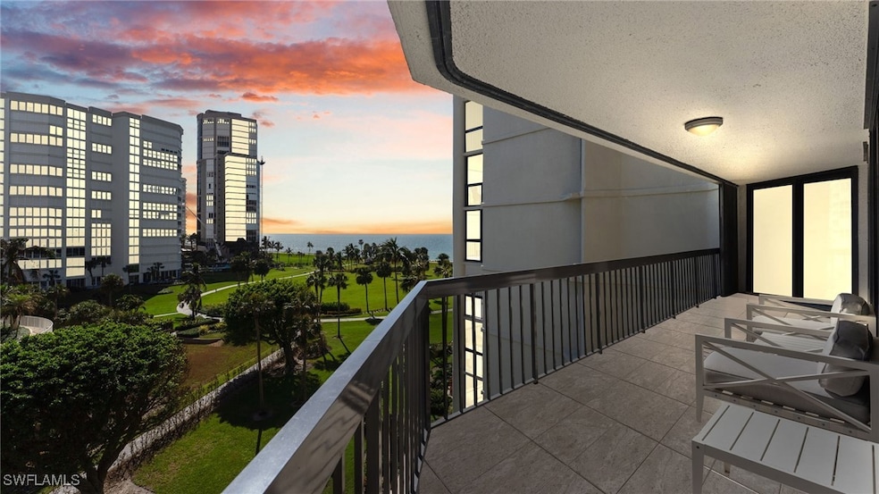 Balcony at dusk featuring a water view