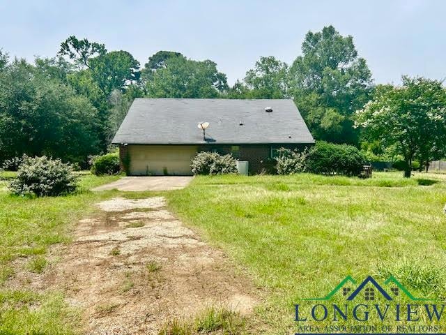 View of front of property with dirt driveway