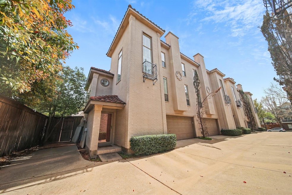 View of property featuring driveway, a garage, and