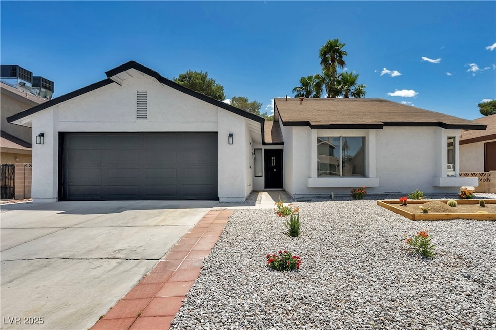 Ranch-style house with stucco siding, an attached