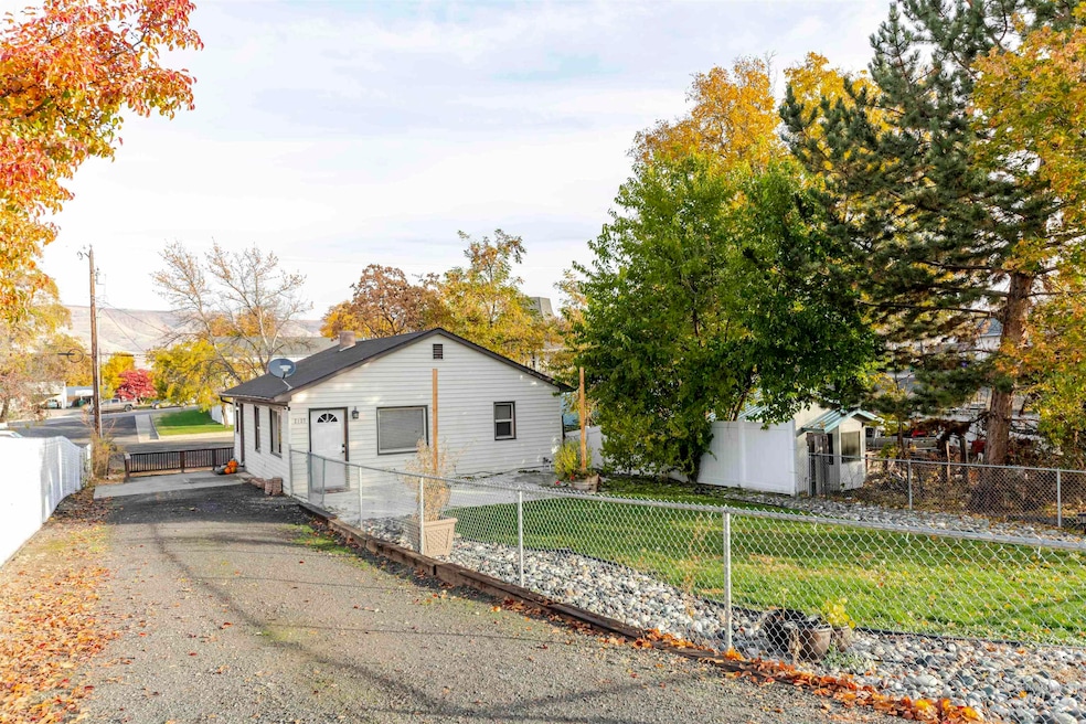 View of side of property with a fenced front yard and a chimney