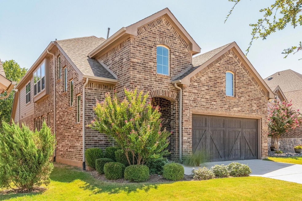 Front facade with a front lawn and a garage
