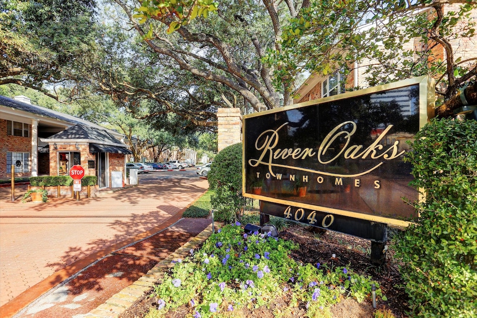 Timeless gated entry to River Oaks Townhomes, framed by mature live oaks and lush landscaping. The elegant signage and 24/7 manned gate welcomes residents and guests to this well-maintained community located in the heart of Houston's prestigious Inner Loop and River Oaks Area.