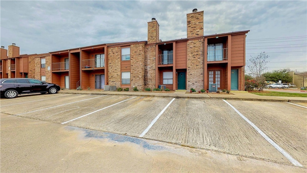 View of property featuring uncovered parking and c