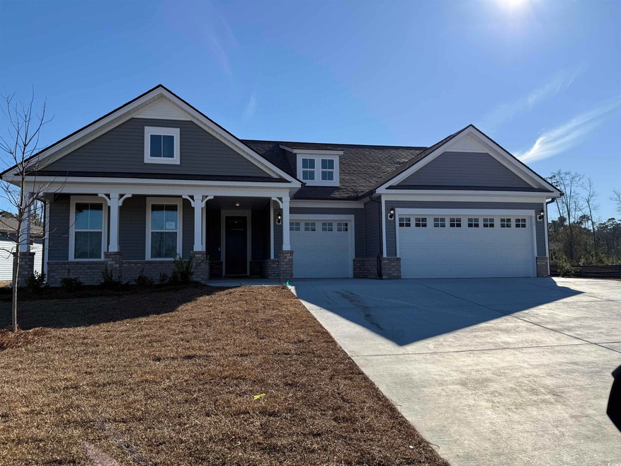 Craftsman house featuring covered porch, driveway,