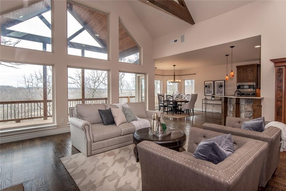 Space and Privacy: This Estate's Great Room w Open Floorplan boasts Tons of Natural Light with Vaulted Wooden Beamed Ceilings and Wall of Windows