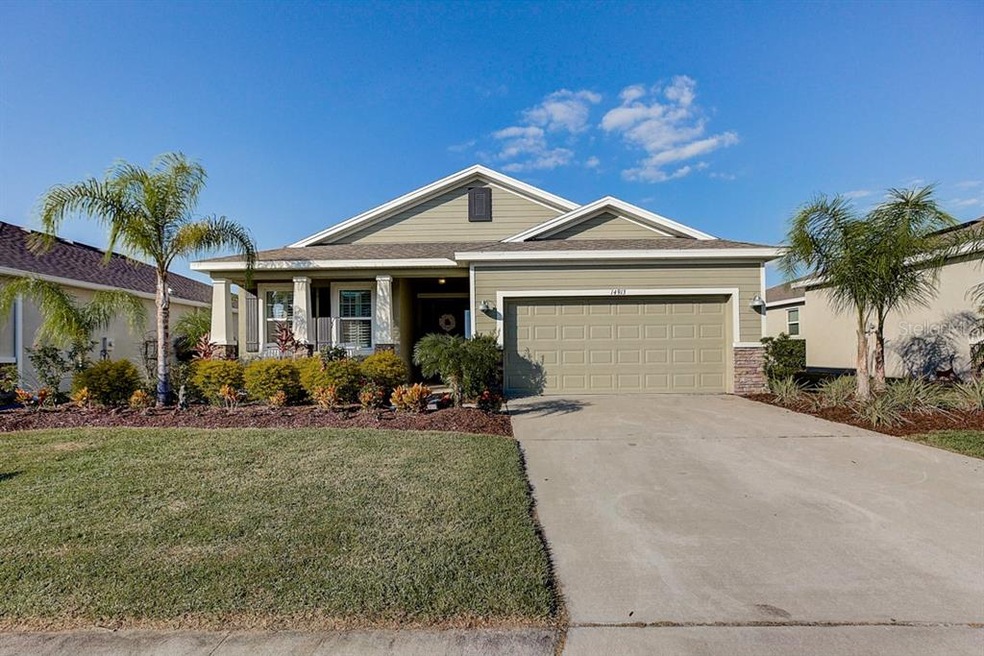 Front on nicely landscaped yard with front porch