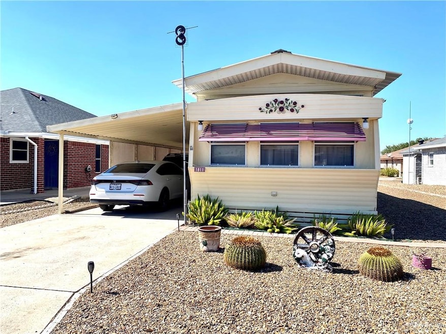 View of front of home featuring concrete driveway and an attached carport