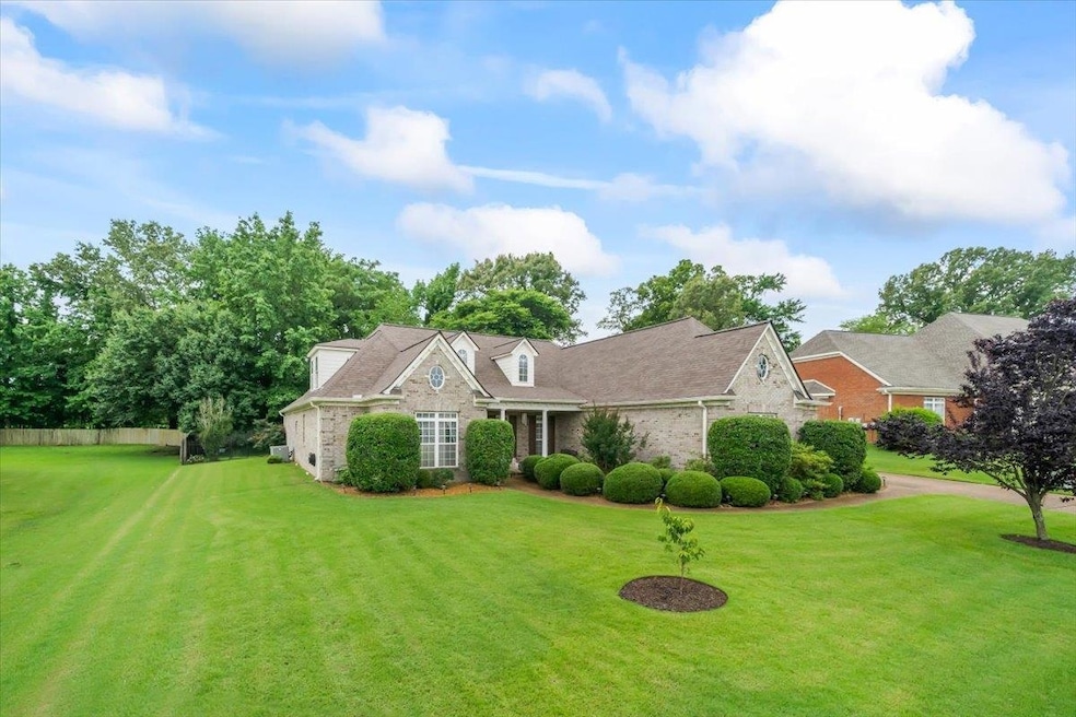 New england style home featuring a front lawn and brick siding