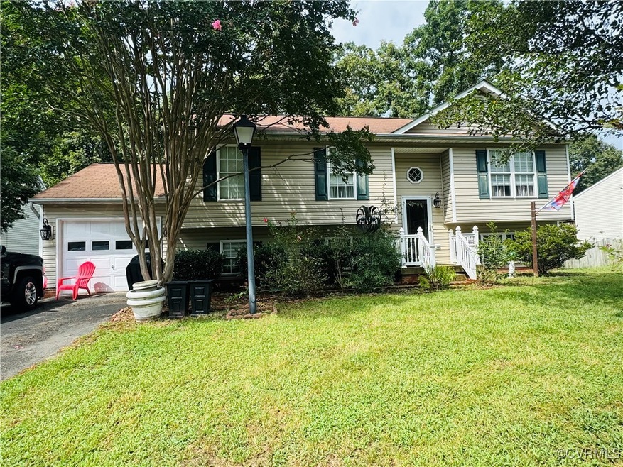 Raised ranch with a garage and a front yard
