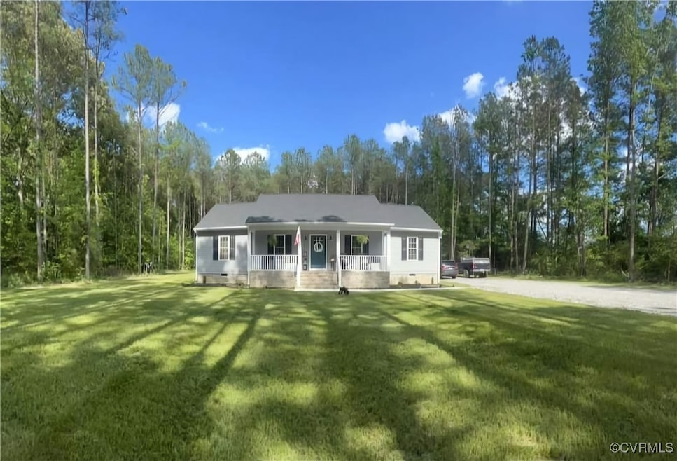 View of front of home with covered porch and a front yard