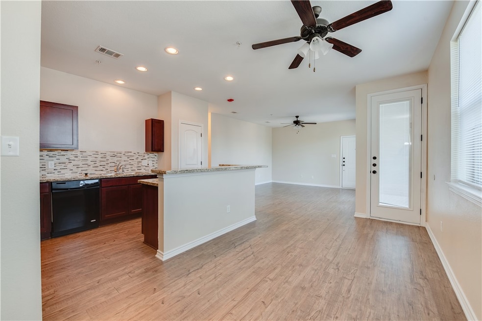 Kitchen featuring visible vents, light wood-style