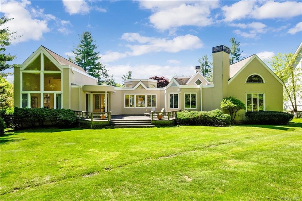 View of back of house and lush lawn.