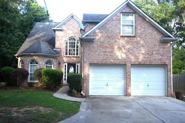 View of front of property with concrete driveway and brick siding