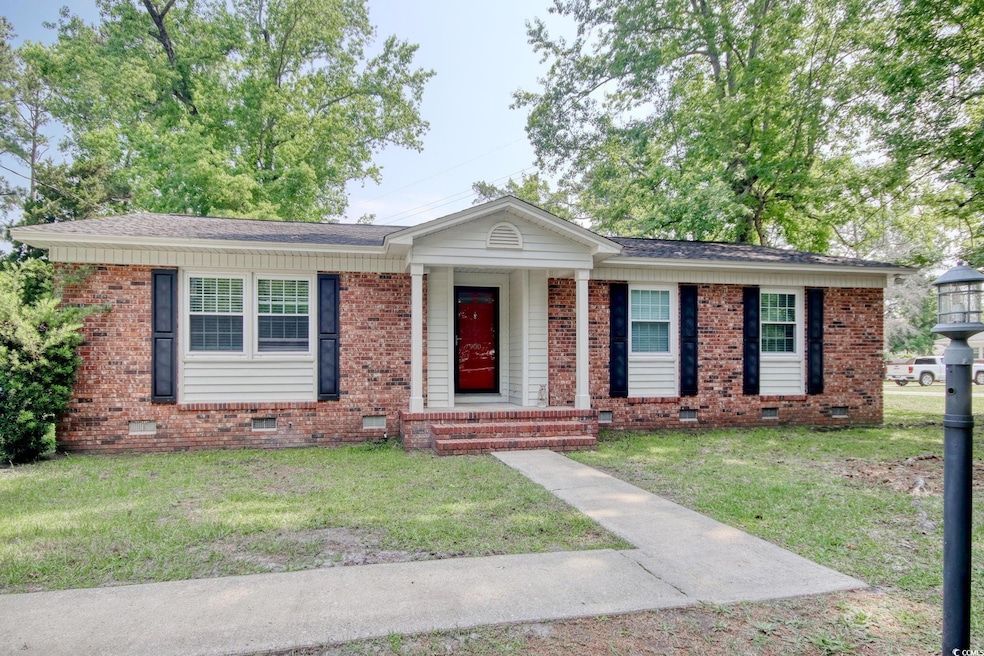 Ranch-style house featuring crawl space, a front lawn, and brick siding